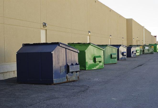 a collection of bright and vibrant dumpsters in a construction zone in Alton